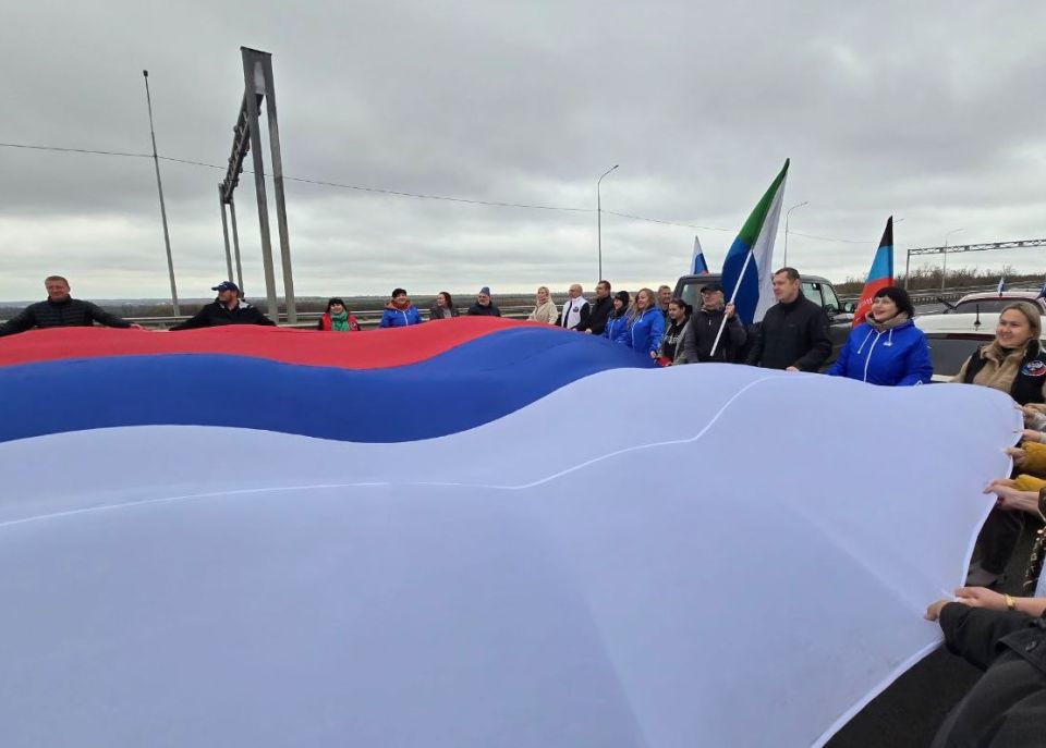 Жители Дебальцево и Брянки растянули огромный триколор на границе ЛНР и ДНР